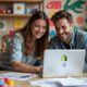 A vibrant workspace with colorful custom products displayed, a laptop open with Shopify on the screen, and two smiling individuals collaborating, surrounded by creative tools and design sketches.